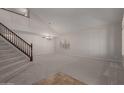 Bright living room featuring vaulted ceilings, neutral carpet, and a staircase at 4643 E Villa Maria Dr, Phoenix, AZ 85032