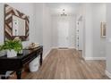 Elegant foyer with wood floors, decorative mirror, and stylish console table at 4834 S Meteor --, Mesa, AZ 85212