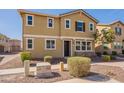 Two-story home with stucco and stone details, featuring a well-kept lawn and a pathway leading to the front door at 504 N Ranger Trl, Gilbert, AZ 85234