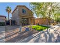 Attractive two-story home with a well-kept lawn, desert landscaping, and extended driveway at 559 E Rainbow Dr, Chandler, AZ 85249