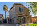 Two-story home featuring desert landscaping with a palm tree, adding a touch of elegance to the facade at 559 E Rainbow Dr, Chandler, AZ 85249