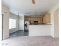 An open floor plan featuring the kitchen with stainless steel appliances and a casual dining area at 559 E Rainbow Dr, Chandler, AZ 85249