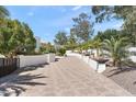 Beautiful winding driveway with patterned brick, desert landscaping, and a white privacy wall at 6216 N 38Th Pl, Paradise Valley, AZ 85253