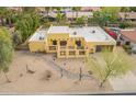 Aerial view of a yellow home with desert landscaping and a private two-car garage at 7719 W Bluefield Ave, Glendale, AZ 85308