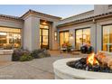 Elegant outdoor patio featuring a cozy fire pit, stylish seating, and a seamless indoor-outdoor flow at 9280 E Thompson Peak Pkwy # 29, Scottsdale, AZ 85255