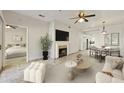 Bright living room featuring a fireplace, ceiling fan, and neutral decor, flowing into the dining area at 9450 E Becker Ln # 2090, Scottsdale, AZ 85260