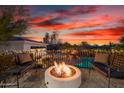 Inviting backyard with a fire pit, seating, and string lights for ambiance at 10800 E Cactus Rd # 7, Scottsdale, AZ 85259