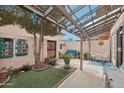 Inviting backyard with shaded pergola, artificial turf, and decorative landscaping at 1144 N 85Th Pl, Scottsdale, AZ 85257