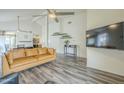 Bright living room featuring vaulted ceilings, a ceiling fan, and modern wood-look floors at 12243 S Chippewa Dr, Phoenix, AZ 85044