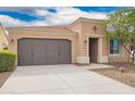 Inviting exterior with a well-maintained lawn, desert landscaping, and a spacious two-car garage at 12957 W Hummingbird Ter, Peoria, AZ 85383