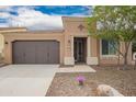 Charming single-story home with desert landscaping and a two-car garage, showcasing curb appeal at 12957 W Hummingbird Ter, Peoria, AZ 85383