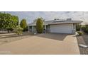 Single-story home featuring well-maintained landscaping, solar panels, and an attached two-car garage at 13807 N Boswell Blvd, Sun City, AZ 85351