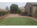 This backyard features a well-manicured lawn, paver patio, and a relaxing spa, perfect for outdoor enjoyment at 13812 W Remuda Dr, Peoria, AZ 85383