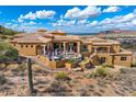 View of the rear exterior featuring a hot tub and a desert landscape with mountain views at 14360 E Desert Cove Ave, Scottsdale, AZ 85259