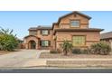 Two-story home showcasing a well-maintained front yard and a covered porch at 14544 W Sierra St, Surprise, AZ 85379