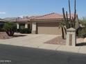 Charming single-story home with a two-car garage and mature desert landscaping at 15104 W Pinehurst W Ln, Surprise, AZ 85374