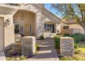 Welcoming front entrance with stone accents, a decorative door, and a charming walkway fountain at 20331 N Fletcher Way, Peoria, AZ 85382