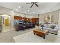 An open concept living room featuring a large kitchen island and comfortable seating area at 20331 N Fletcher Way, Peoria, AZ 85382