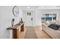 Bright entryway with wood floors, stylish console table, modern decor and entry door at 2202 E Lincoln Dr, Phoenix, AZ 85016