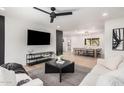 Open living room with light wood floors, modern furnishings and seamless flow to the dining area at 2202 E Lincoln Dr, Phoenix, AZ 85016