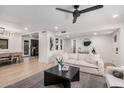 Bright living room with modern black accents, and a view of the adjacent kitchen and dining areas at 2202 E Lincoln Dr, Phoenix, AZ 85016