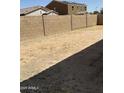 Spacious backyard with a block wall, offering privacy and potential for customization at 25766 W Valley View Dr, Buckeye, AZ 85326