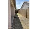 Side yard featuring gravel and a block wall, perfect for storage or landscaping at 25766 W Valley View Dr, Buckeye, AZ 85326