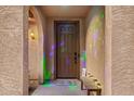 View of door and entryway to tan home. Bench with candles on the right at 291 N Scott Dr, Chandler, AZ 85225