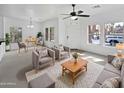 Bright living room with plush seating, modern ceiling fan, and large windows for natural light at 3316 W Hayduk Rd, Laveen, AZ 85339