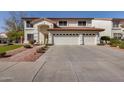 A home with a three-car garage, desert landscaping, and an arched entryway at 5778 W Corrine Dr, Glendale, AZ 85304