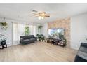 Bright living room with stone accent wall, modern furnishings, and lots of natural light at 6541 N 41St Ave, Phoenix, AZ 85019