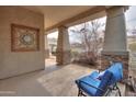 Inviting outdoor space with a comfortable lounge chair and decorative wall art at 682 W Rambler Ct, Casa Grande, AZ 85122