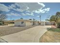 Single-story home with desert landscaping and a long driveway at 6851 E Windsor Ave, Scottsdale, AZ 85257