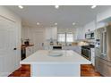 Bright, modern kitchen with white cabinets, stainless steel appliances, and a center island at 6851 E Windsor Ave, Scottsdale, AZ 85257