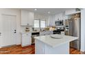 Modern kitchen with white cabinets, stainless appliances, and island at 6851 E Windsor Ave, Scottsdale, AZ 85257