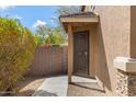 Close-up of a home's secure front door and side yard landscaping at 7307 W Nicolet Ave, Glendale, AZ 85303