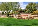 Beautiful community entrance sign surrounded by colorful flowers and manicured landscaping at 7818 E Cactus Wren Rd, Scottsdale, AZ 85250