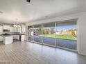 Open-concept living space with tile floors and large sliding glass doors leading to the outdoor area at 842 E Beverly Rd, Phoenix, AZ 85042