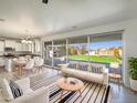 Bright living room with modern furniture, hardwood floors, and sliding glass doors to the backyard at 842 E Beverly Rd, Phoenix, AZ 85042