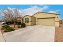 Charming single-story home featuring a well-maintained front yard with a two-car garage and desert landscaping at 9700 E Harvest Rd, Florence, AZ 85132