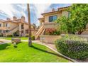 Beautiful condo complex surrounded by green lawns and colorful foliage, creating an inviting atmosphere at 9711 E Mountain View Rd # 2524, Scottsdale, AZ 85258