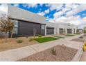 Street view of modern gray homes, each featuring xeriscaped landscaping and sleek contemporary design at 10302 E Utah Ave, Mesa, AZ 85212