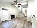 Bright living room with wood flooring, modern fireplace, and an open staircase leading to the loft at 1222 W Baseline Rd # 159, Tempe, AZ 85283