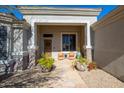 Inviting front porch with seating area and decorative potted plants at 12706 E Desert Cove Ave, Scottsdale, AZ 85259