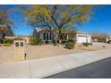 Well-manicured front yard with mature landscaping and a traditional house design at 12706 E Desert Cove Ave, Scottsdale, AZ 85259