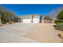 Charming single-story home featuring a three car garage and desert landscaping at 12706 E Desert Cove Ave, Scottsdale, AZ 85259