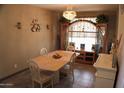 Traditional dining room with chandelier, table, and large wooden cabinet at 13612 W Desert Moon Way, Peoria, AZ 85383