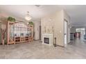 Bright living room featuring tile floors, neutral paint, and a decorative fireplace at 13612 W Desert Moon Way, Peoria, AZ 85383