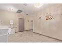 Neutral-toned living space featuring tile floors, modern decor, and ample natural light at 13612 W Desert Moon Way, Peoria, AZ 85383