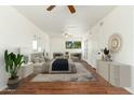 Bright and airy main bedroom featuring a ceiling fan, wood floors, and neutral walls at 13807 N 33Rd Dr, Phoenix, AZ 85053